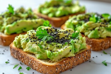 Delicious avocado toast topped with black sesame seeds and fresh herbs for a healthy breakfast option. Slices of whole grain bread are generously spread with creamy avocado dip, nutritious snack food