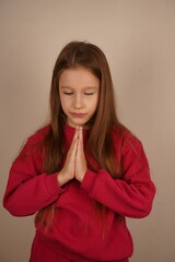 A tender and sincere moment is beautifully captured. A young girl with long red hair clasps her...