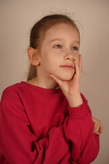 The expression captures a moment of personal insight and introspection. The girl in red rests her...