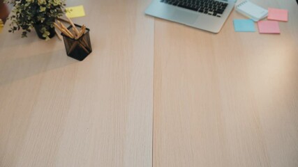 Diverse hands come together to assemble wooden gears on a light wooden table, symbolizing teamwork, collaboration, and creativity in a modern work environment. SACTR