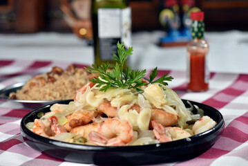 codfish typical Portuguese dish baked cod with onion garlic peppers and potatoes rustic Portuguese food salted fish cooked olive oil