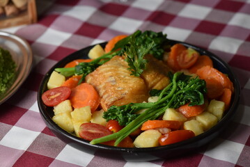 codfish typical Portuguese dish baked cod with onion garlic peppers and potatoes rustic Portuguese food salted fish cooked olive oil