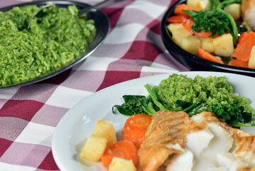 codfish typical Portuguese dish baked cod with onion garlic peppers and potatoes rustic Portuguese food salted fish cooked olive oil