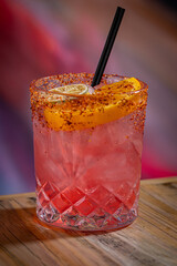 Short Pink Cocktail with Tahini Rim and dried fruit.