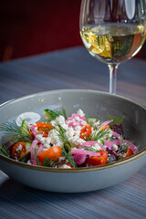 Beet Salad with Tomatoes, Feta and Dill with a glass of white wine.