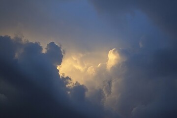 Pale dull blue gray white yellow sky with heavy clouds. Dramatic background. Storm hurricane wind rain lightning cloudy dark. Ominous scary creepy.