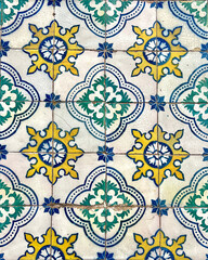 Close-up of a geometric tile pattern with blue, yellow, green and black colors