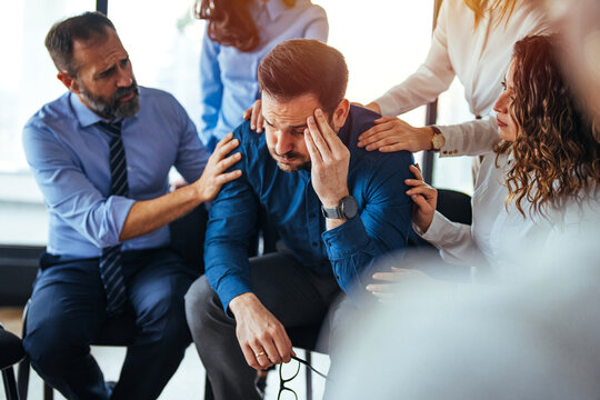 Supportive Team Encouraging Colleague During Emotional Stress In the Workplace
