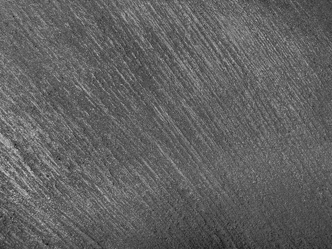 Dark rough abstract texture of sloped, curved lines. Manly, brutal, courageous, stylish rude background. Design concept. Copy space. Black and white.