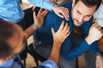 Supportive Friends Comforting a Man During a Group Meeting or Discussion