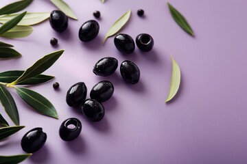 Fresh black olives and olive leaves lying on a purple background