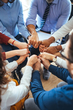 Diverse Team Fist Bump Symbolizing Unity and Teamwork