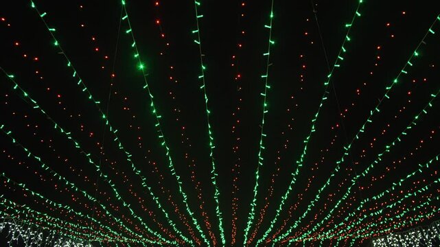 Holiday illumination at the top Green and red lights background on black