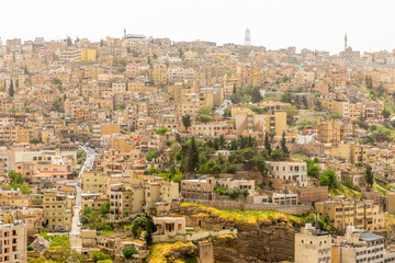 Obraz premium Lots of residential houses densily scattered on the hills in the downtown of Amman city, Kingdom of Jordan