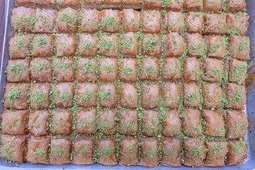 Turkish baklava dessert sprinkled with pistachio crumbs.