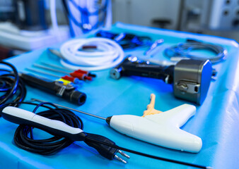 Sterile table with tools. Surgical instruments are arranged on a sterile surface in an operating...