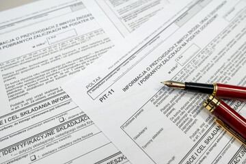 Fototapeta premium PIT-11 polish tax form on accountant table with pen close up. Tax time