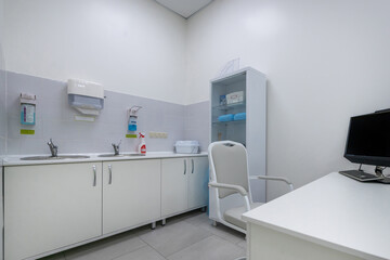 An office designed for medical admission in an outpatient clinic. Interior with shelving, sink and soap dispensers.