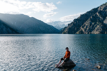 Exploring the Tranquil Beauty of Kyrgyzstan's Mountains and Lake in the Warm Embrace of Daylight