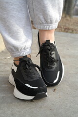 Naklejka premium stylish girl wearing trendy women's sneakers