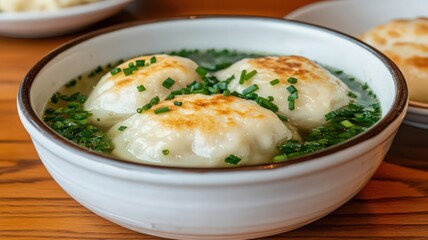 Three Pan-Fried Dumplings in Broth with Green Onions