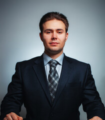 Young handsome man in black suit official studio portrait