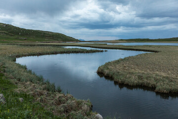 Hayeli (Mirror) Lake near Artavan village, Vayots Dzor, Armenia, is a stunning alpine lake reflecting the dramatic sky. It replicates world map. A popular destination for hiking, trekking and camping 
