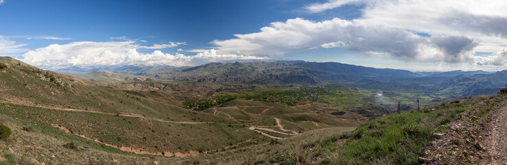 Aerial panoramic view of Vernashen village and Yeghegnadzor, the center of Vayots Dzor province, Armenia. A vast mountainous valley with settlements, farmlands, and winding roads