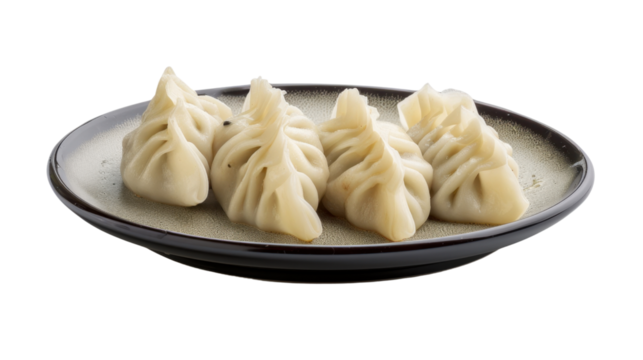 Steamed dumplings resting on a dark plate with transparent background