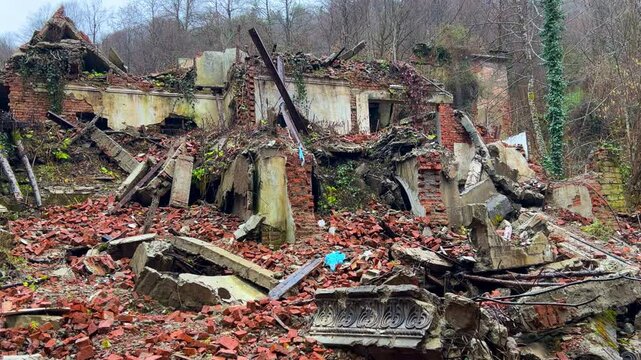 The ruined, lost, overgrown mining ghost town of Akarmara in the rain, the aftermath of the war in Abkhazia, in the mountains. A city on a cloudy winter day located near Tkvarcheli. Georgia.