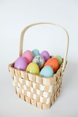 Woven basket with colorful Easter eggs.