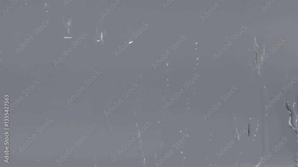 Poster blurry window with streaks of water on it. the window is covered in a thin layer of water, and the s