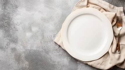 A simple, elegant empty plate rests on a beige linen napkin against a rustic brown background, perfect for presentations.