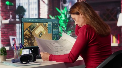 Freelancer designer decorates apartment floor plan using blueprints on pc, using architectural software to configure elements. Woman uses interface to enable rendering and 3D modeling. Camera A.