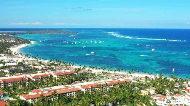 Tropical coastline with resorts, palm trees and caribbean sea. Travel destinations. Dominican Republic. Aerial view