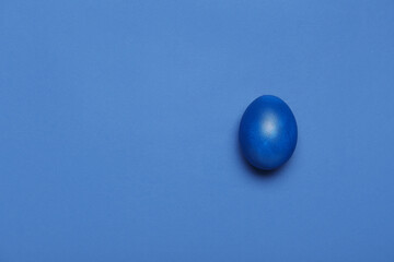 Painted Easter egg on blue background