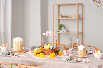 Beautiful table setting for Easter cakes and eggs in dining room