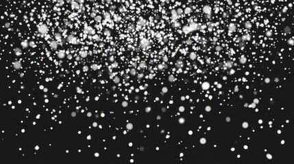 Falling snowflakes on black background creating a winter wonderland effect