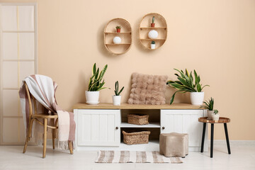 Interior of room with chair, bench and green plants