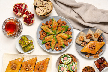 Composition with different Eastern dishes and cup of tea on light background. Ramadan celebration