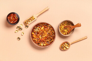 Composition with bowls and spoons with fish oil capsules on color background