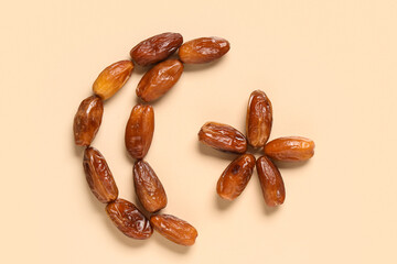 Crescent and star made of tasty dried dates on color background. Ramadan celebration