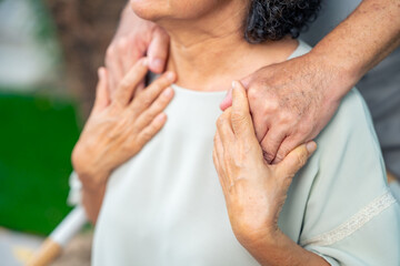 Happy Asian family senior couple enjoy and fun leisure activity lifestyle dancing together in living room. Healthy elderly husband and wife relaxing at home. Aged people mental healthcare concept.