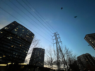 Electric transmission tower with buildings silhouette in Istanbul, Turkey.