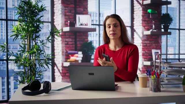 Displeased angry person yelling on the telephone line in her loft, getting frustrated with her staff and being worried. Concerned woman frustrated with the lack of efficiency of the staff. Camera B.