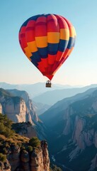 Obraz premium Colorful balloon floats above dramatic mountain range , mountains, hot air balloon, clouds