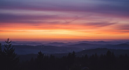 Obraz premium Breathtaking Sunset Over Rolling Hills and Distant City Lights Landscape Photography