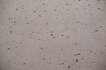 Grey concrete texture with small air pockets and subtle color variations creating a rough industrial surface Background material