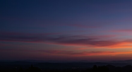 Obraz premium Serene Sunset Landscape Vibrant Sky with Pastel Hues Over Distant Hills