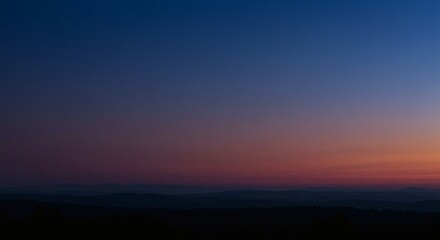 Obraz premium Serene Sunset Landscape Tranquil Evening Sky Over Rolling Hills and Distant Mountains